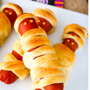 hotdogs wrapped in pastry and decorated to look like mummys