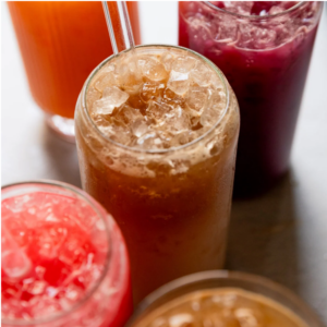 glasses filled with ice and different kinds of soda