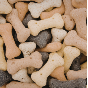 lots of bone shaped dog treats that are light brown, dark brown or beige