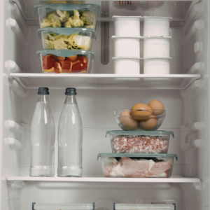 the inside shelf of a fridge with containers and bottles