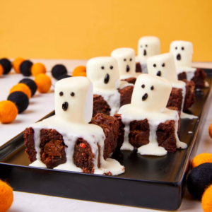 brownies topped with marshmallows with ghost faces on them