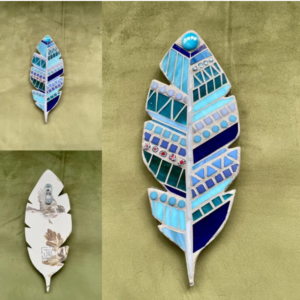 3 feather shaped crafts decorated with a mosaic pattern