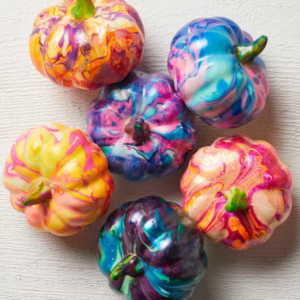 small pumpkins painted with multi coloured paints