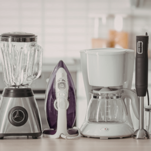 a blender, iron, coffee maker and immersion blender on a counter