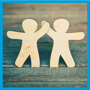 Two wooden figures holding hands.